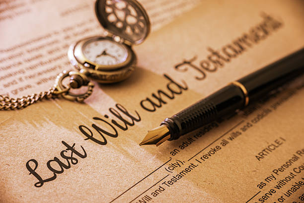 Vintage / retro style with a long shadow : Fountain pen, a pocket watch on a last will and testament. A form is printed on a mulberry paper and waiting to be filled and signed by testator / testatrix.