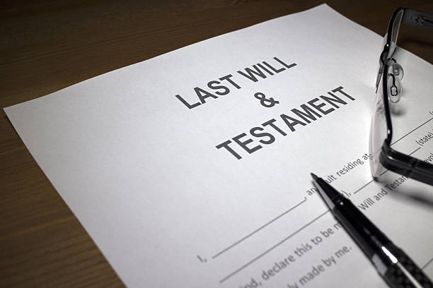 Someone filling out Last Will and Testament document. Someone filling out Last Will and Testament document.